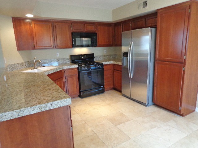 gorgeous kitchen with granite tile counters & travertine floors