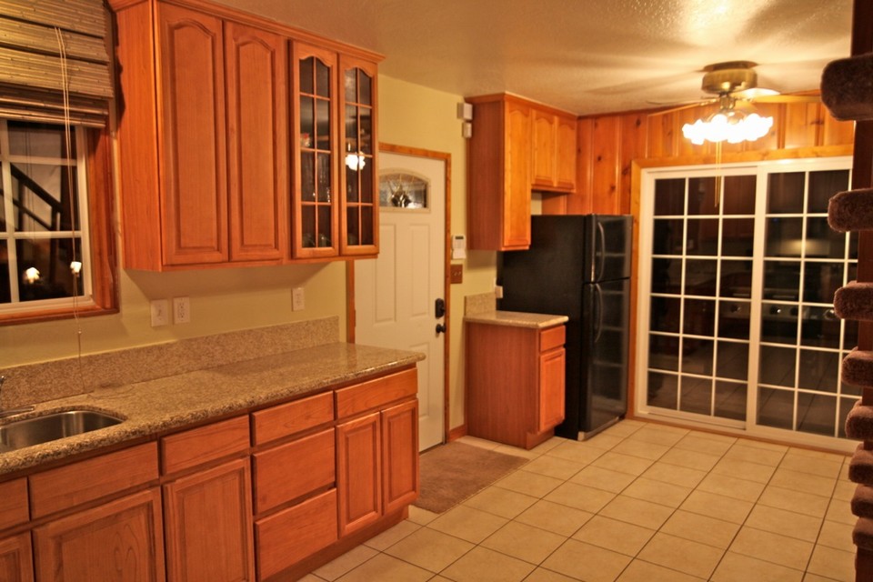 view toward front door and sliders leading to small bbq deck
