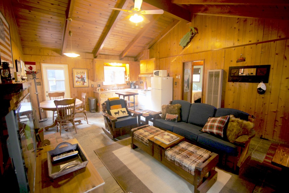 vaulted ceilings with living room, dining room and kitchen open to each other