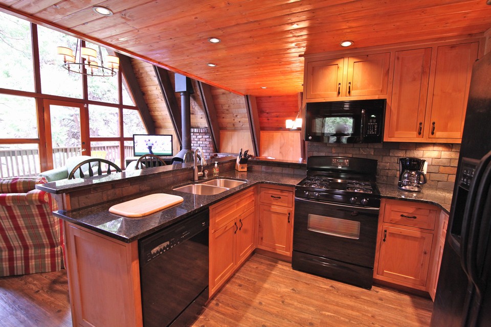 fully remodeled kitchen with custom knotty alder wood cabinets