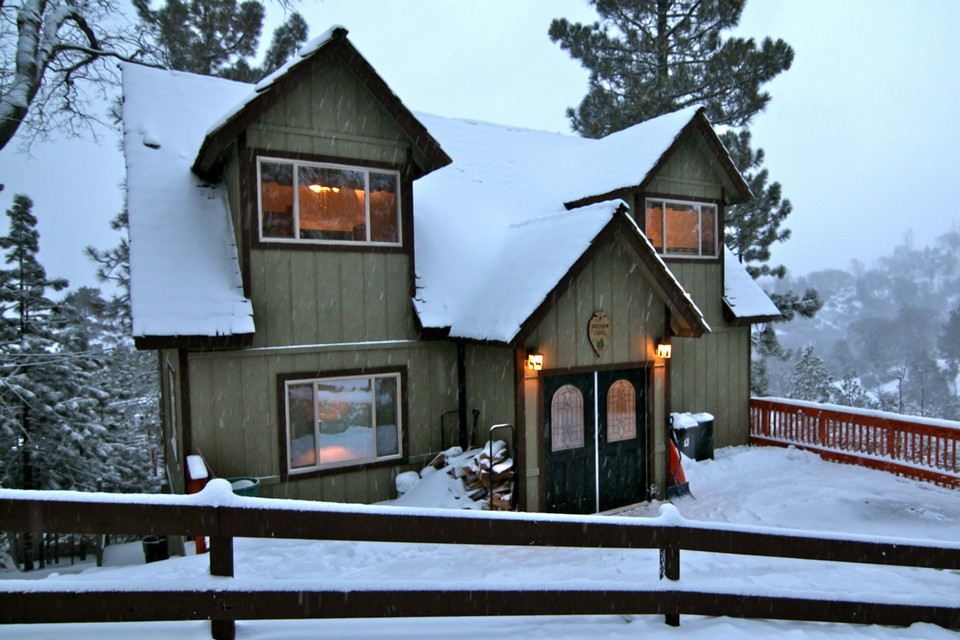 front view of cabin during a winter storm