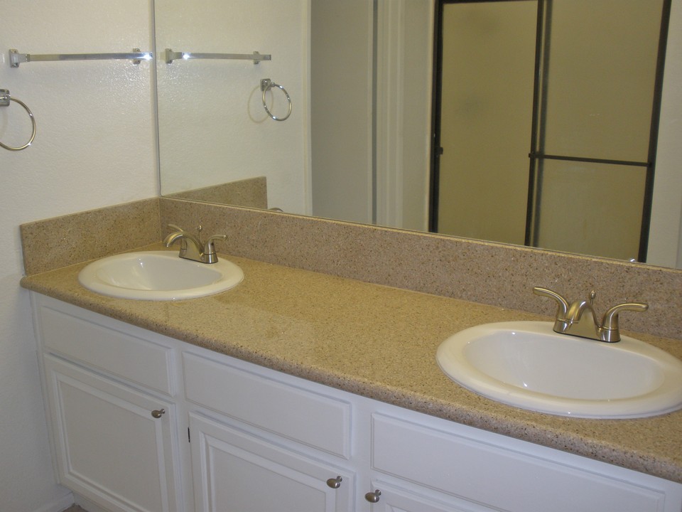 master bath with granite counter and dual sink vanity
