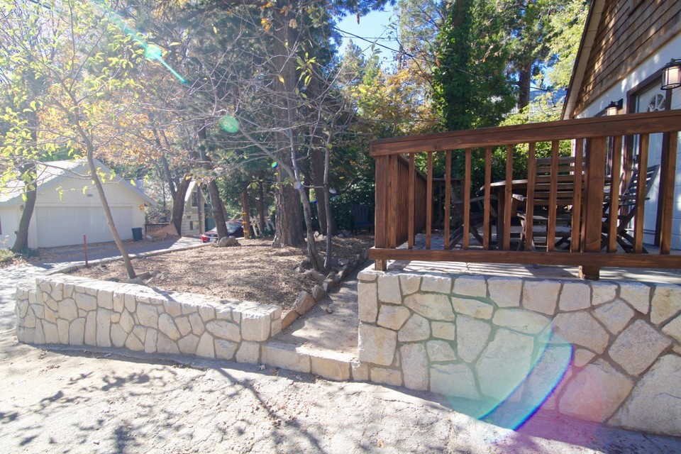front yard surrounded by custom stone retaining wall