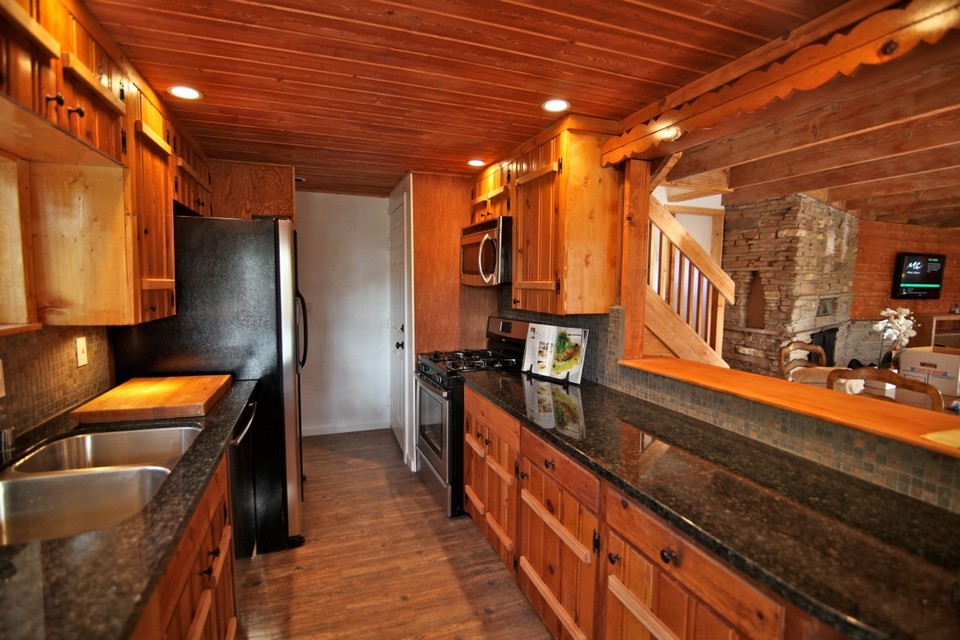 kitchen toward back door and interior stair access to attached garage