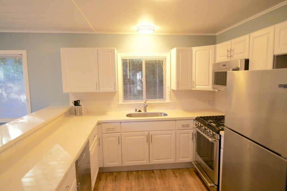 white quartz counter tops and stainless steel appliances