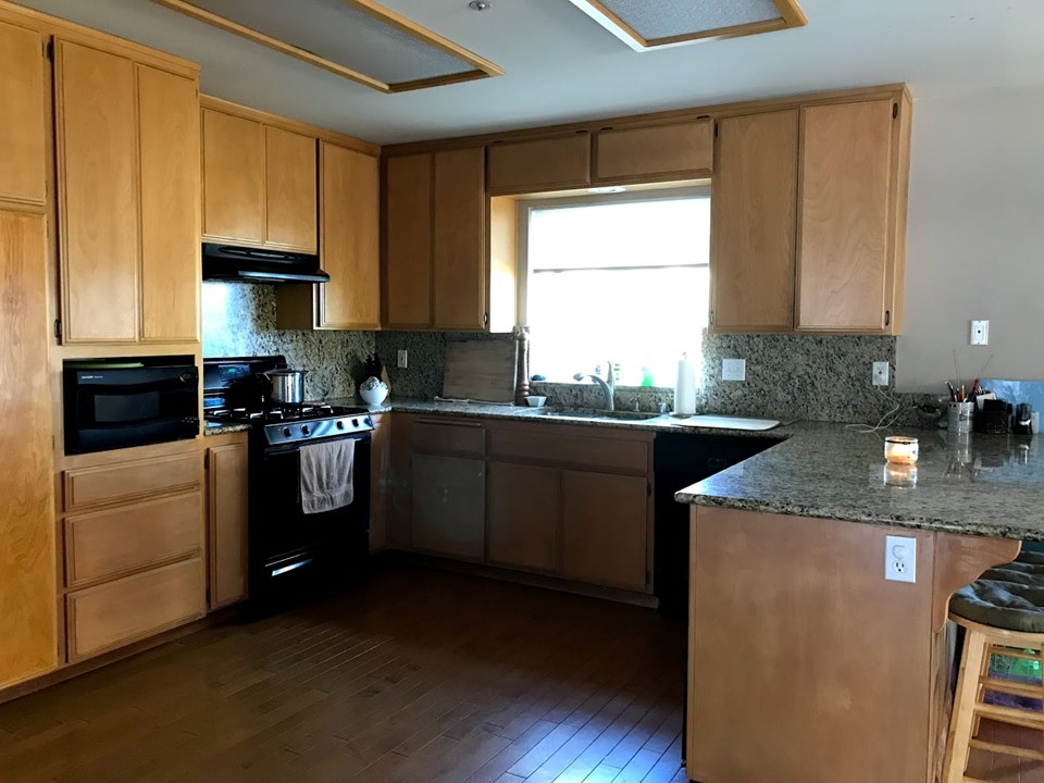 nice kitchen with wood floors and granite counters
